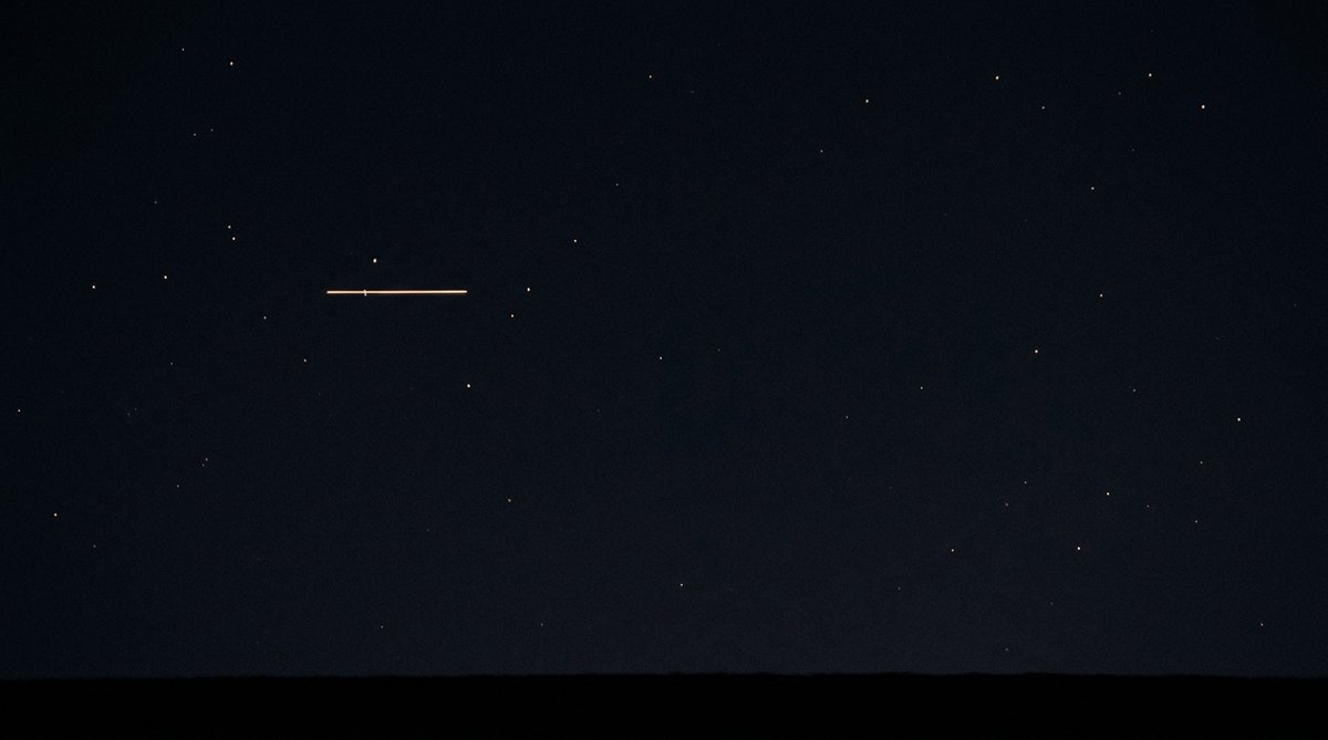 One light drawn into a short streak by its own motion while the stars around it stay sharp points