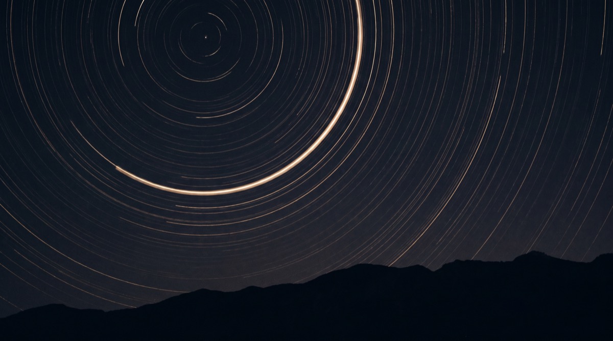 Star-trail arcs circling the celestial pole in a long-exposure night sky